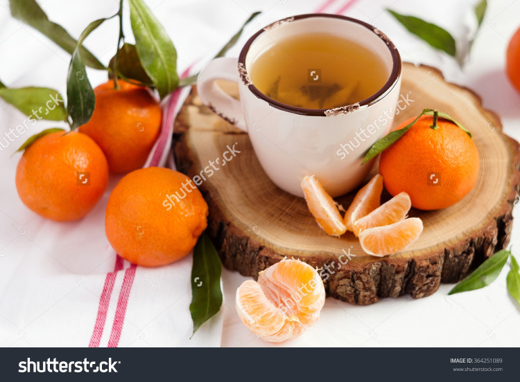 Cup of green tea and fresh mandarins
